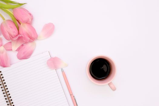 Aesthetic flat lay featuring a cup of coffee, pink tulips, and a spiral notebook.. aesthetic, flat, featuring