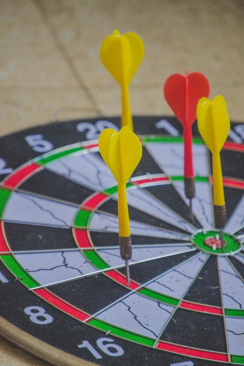 Free Red and Yellow Darts on a Dart Board Stock Photo