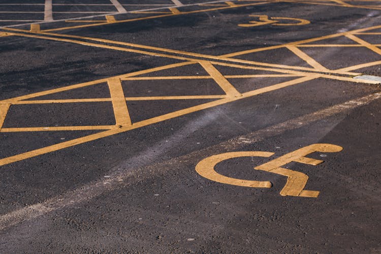 Disabled Parking Signs On  Asphalt Pavement