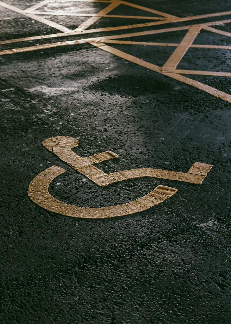 Disability Icon Painted On Asphalt Pavement