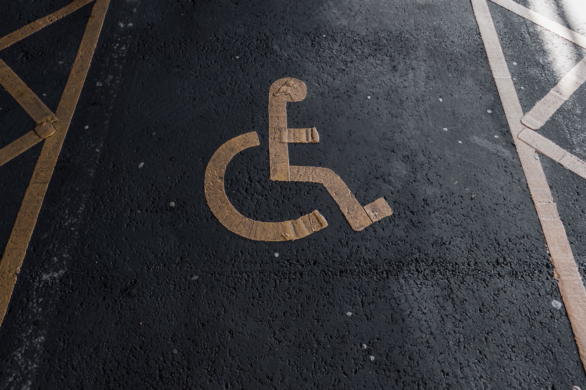 Close-up of a handicapped parking sign painted on pavement for accessibility clarity.