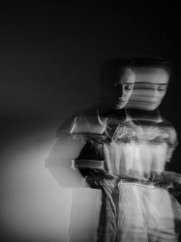 Creative black and white portrait of a woman with blurred motion effect, captured in studio.