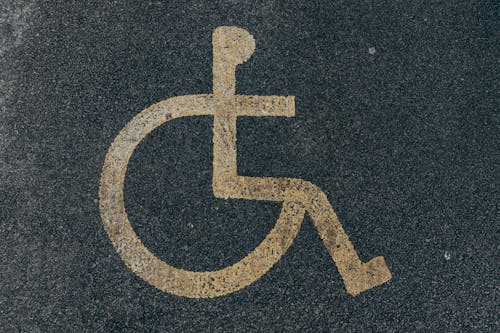 Painted Disability Icon on Asphalt Pavement