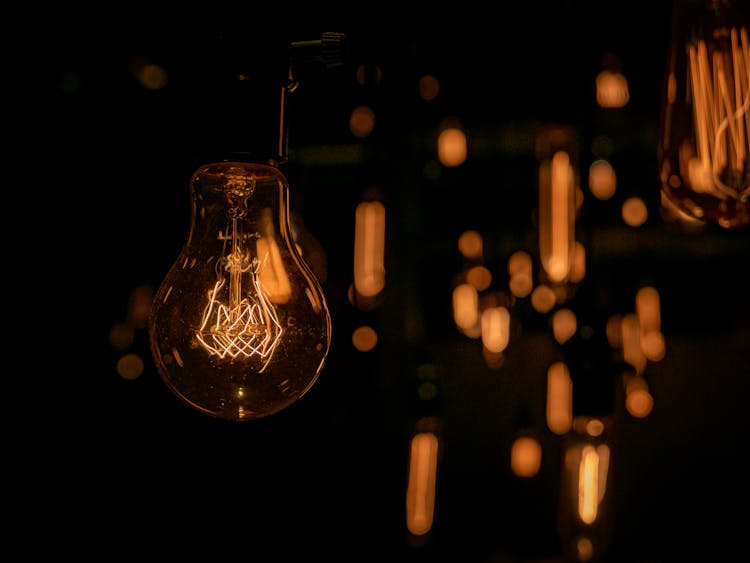 Close-up Of Lightbulb On Dark Background With Lights