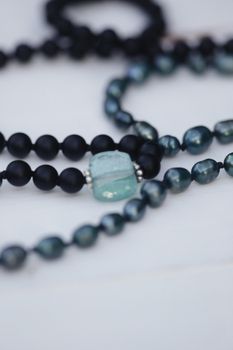 Detailed view of black and blue beaded necklaces with gemstones for jewelry design inspiration.
