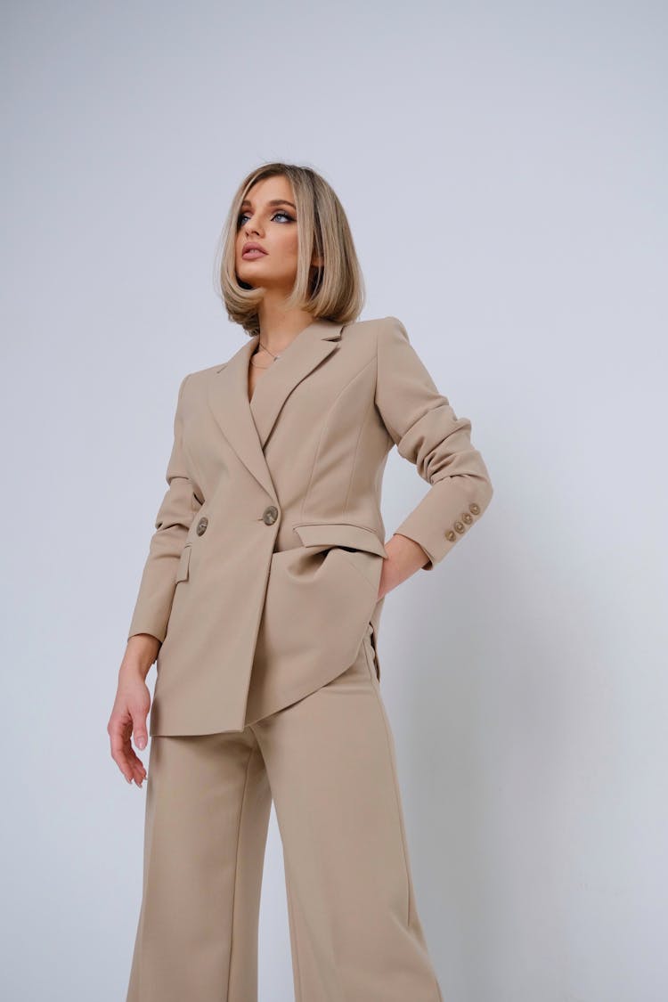 Blond Female Model Wearing Beige Ladies Suit