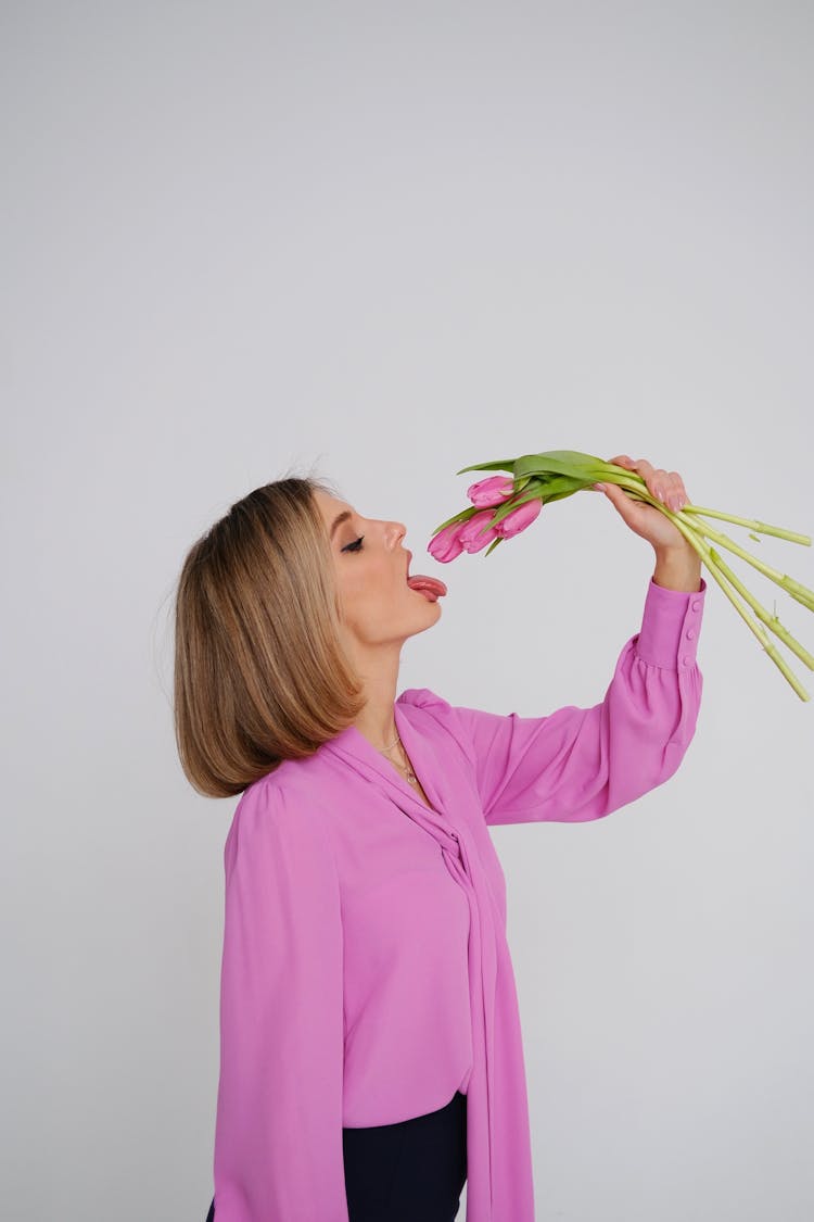 Woman Holding Tulips Over Open Mouth