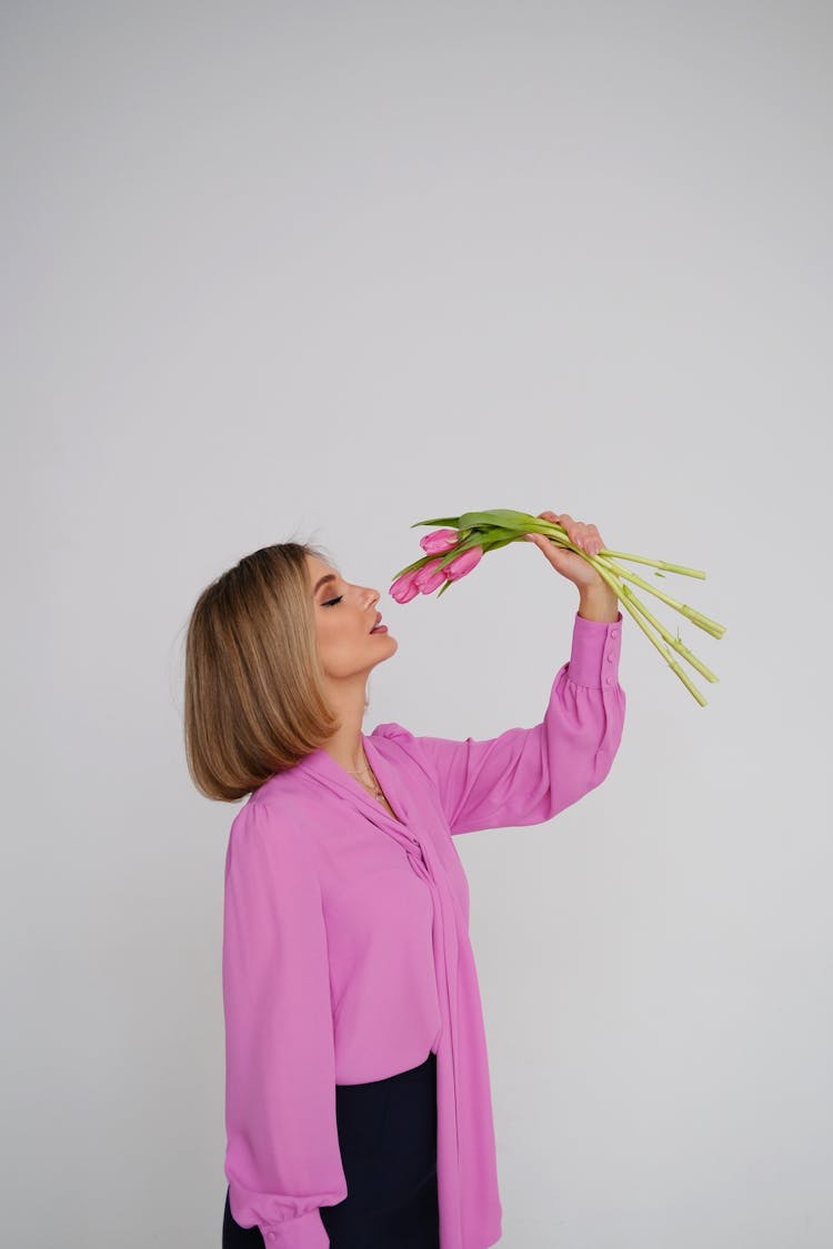 Woman Holding And Smelling Bunch Of Tulips 