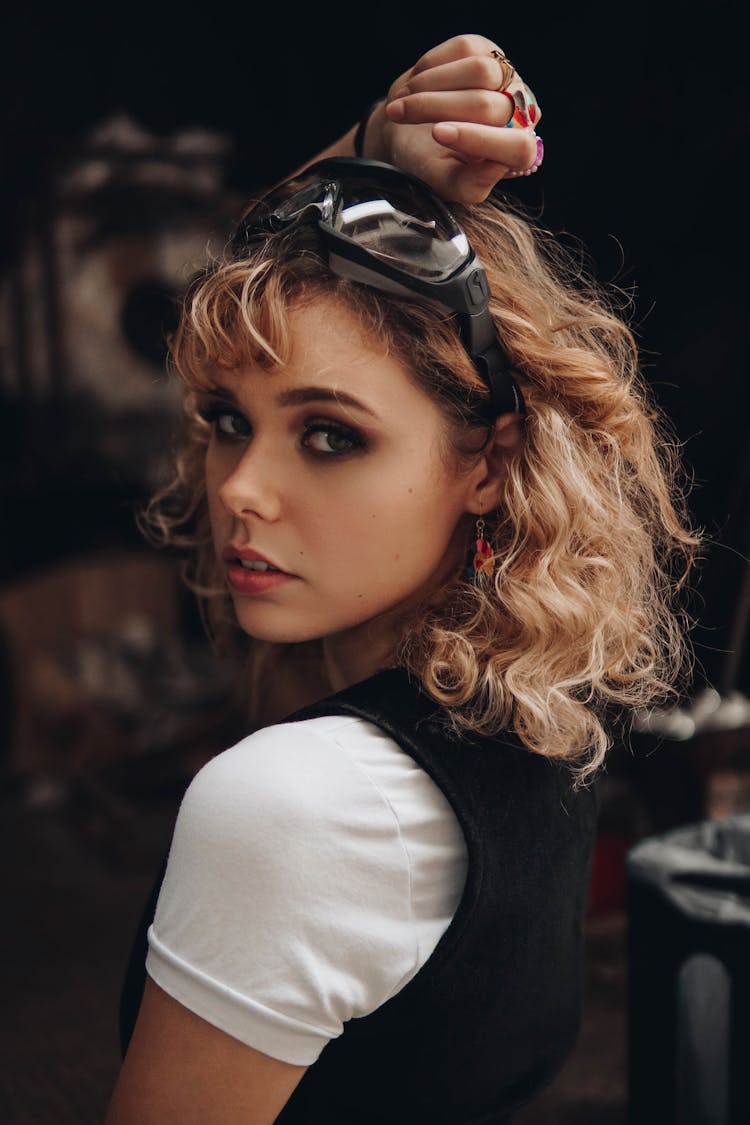 Attractive Woman With Blond Wavy Hair Looking Over Shoulder