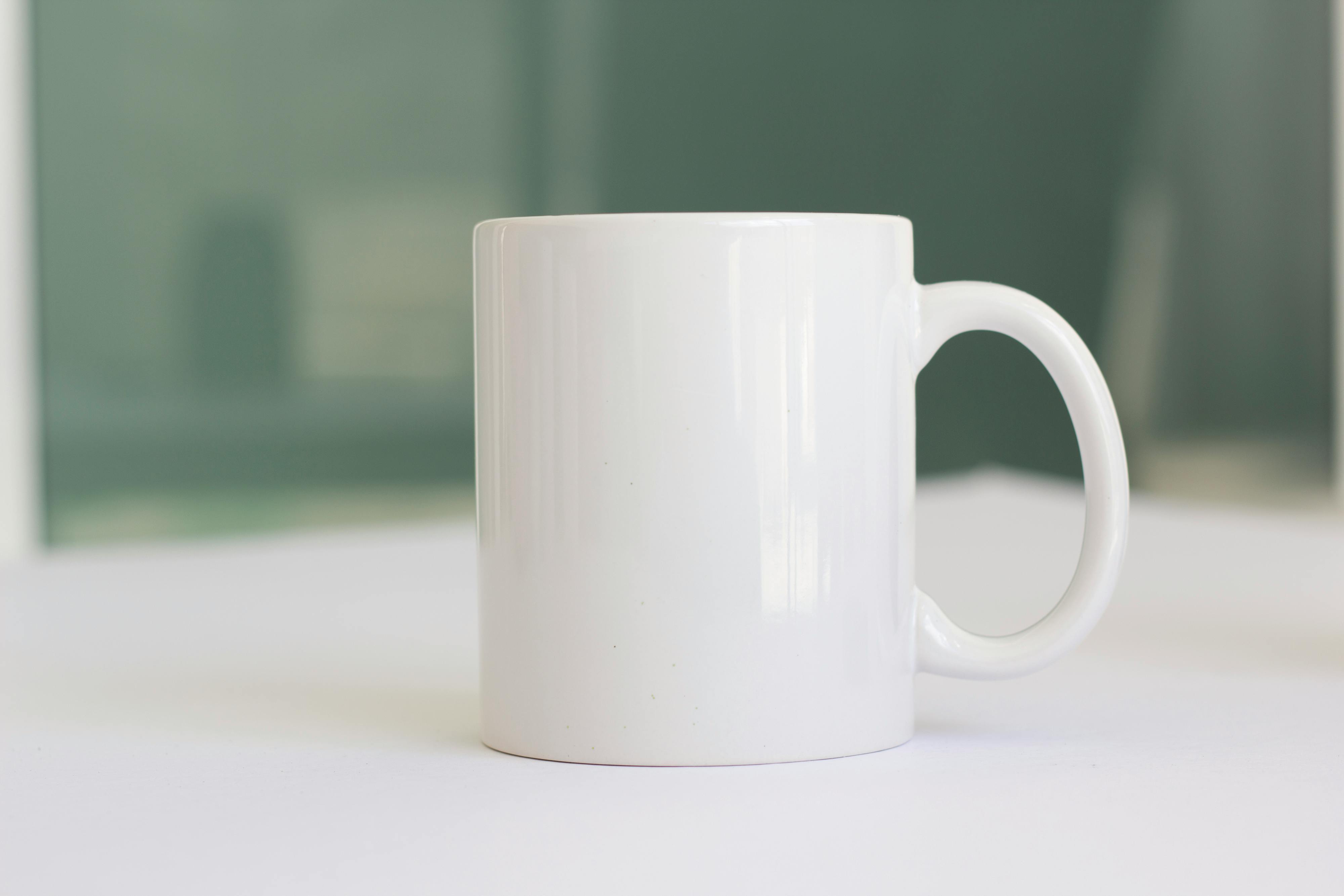 White ceramic mug with coffee on book page photo – Free Coffee cup Image on  Unsplash