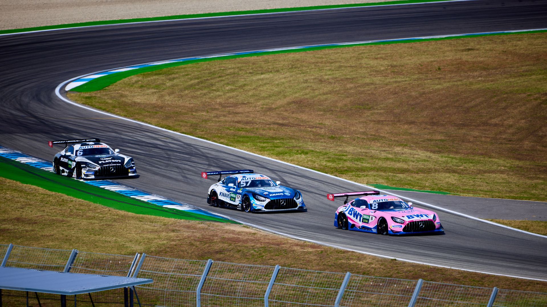 Exciting sports car race on Hockenheim Circuit, showcasing speed and skill on the track.