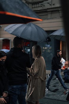 People walking under umbrellas on a rainy day in İstanbul, Türkiye