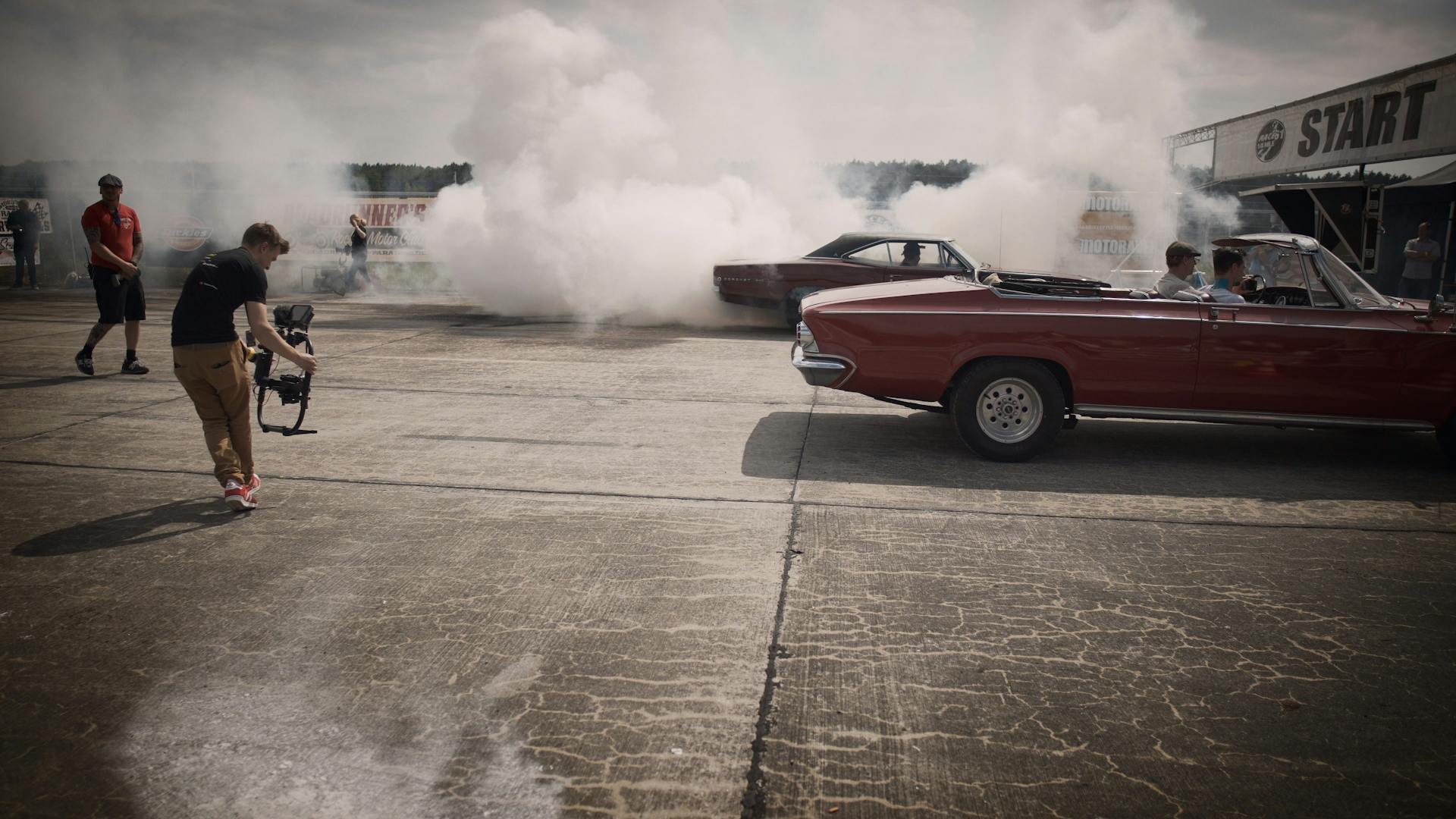 Car Covered With Smoke on Pavement