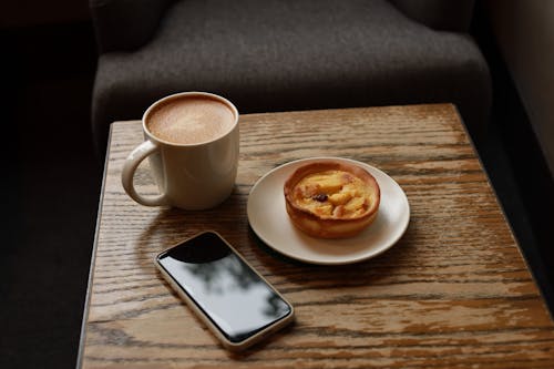 Free Cup of Hot Drink and Pie on a Saucer Stock Photo