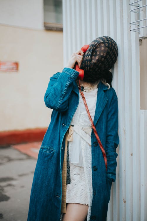Woman with Covered Face Talking on Phone