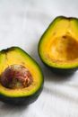 Ripe and Delicious Avocado Fruit Cut in Halves with Big Stone 