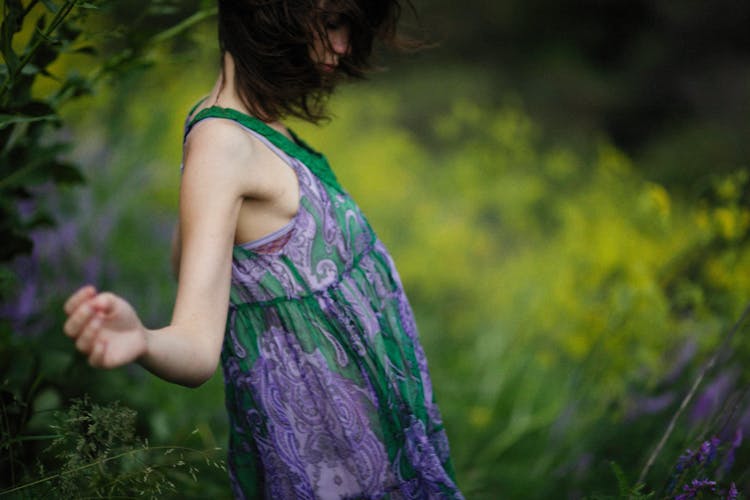 Skinny Woman In Purple And Green Tank Top Running On Yellow Field