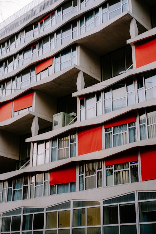 Facade of a Modern Apartment Building with Red Window Blinds 