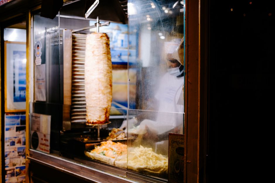 A bustling local cafeteria in Oman, serving budget-friendly shawarma and other quick bites to locals.