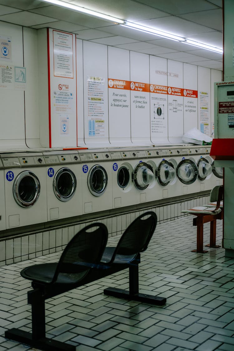 Laundry Machines And Chairs At Laundromat