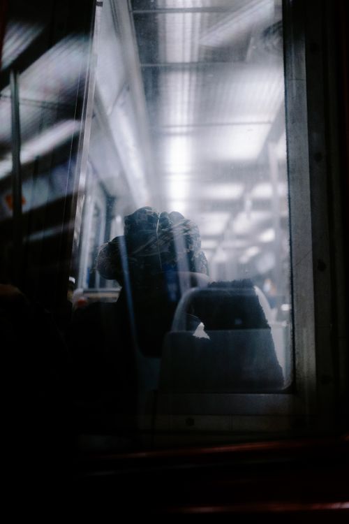 Free View through a train window capturing a serene ambiance with reflections and lighting. Stock Photo