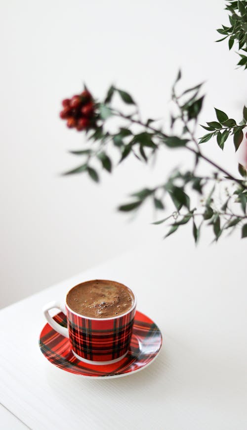 Coffee on White Table and Plant