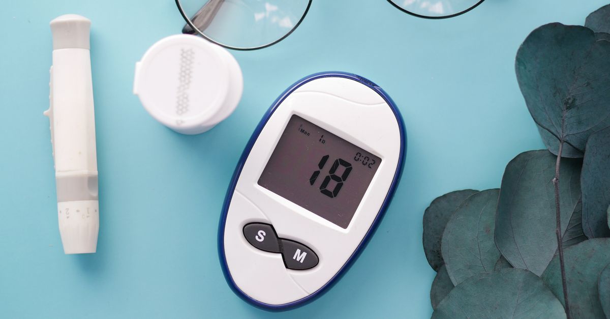 A top view of a glucometer, test strip, and glasses on a blue background, symbolizing health management. - Evidence evidence guide for bilberry blood glucose meta-analysis