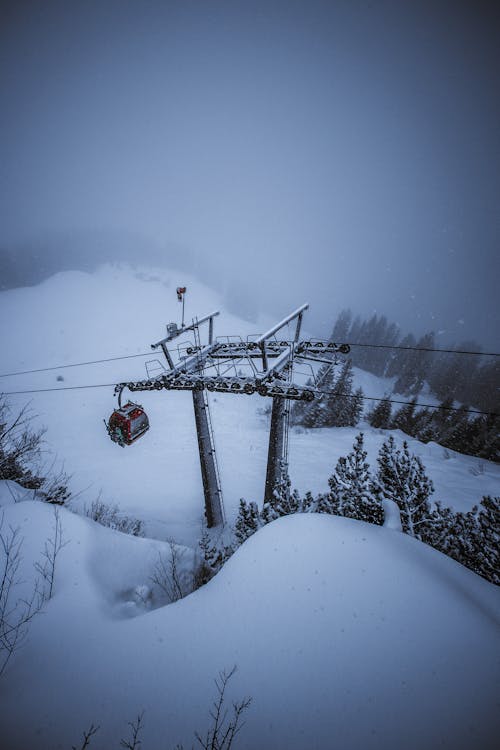 Aerial Photography of Red Ski Lift over Snow Covered Ground
