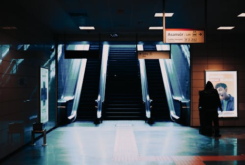 Photo of a Staircase Between Escalators