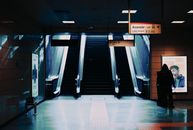 White and Black Escalator Inside Building