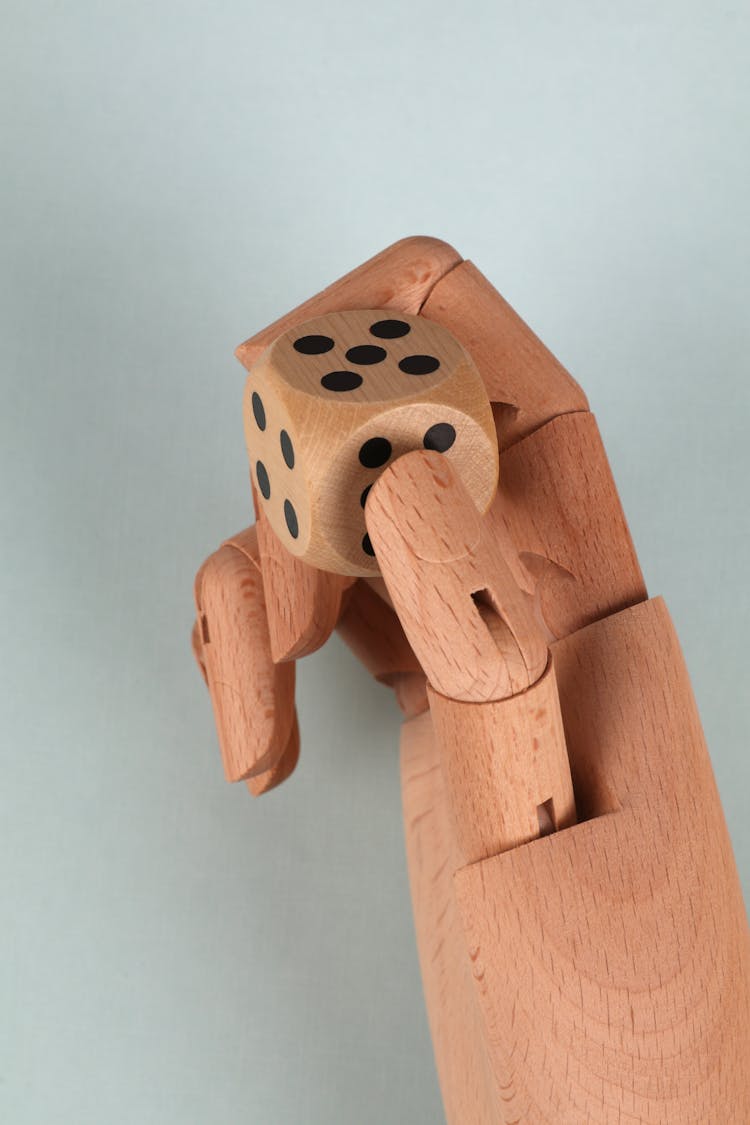 Photo Of A Wooden Hand With A Die