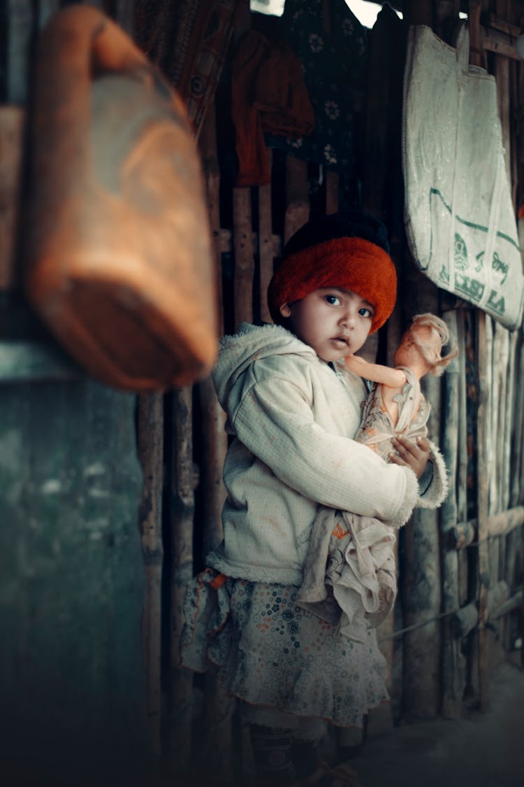 A Cute Girl Carrying A Doll 