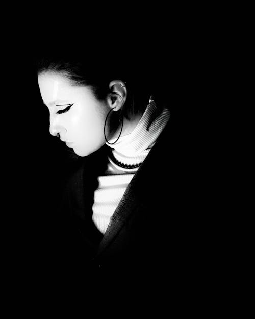 Grayscale Photo of a Woman with Hoop Earring