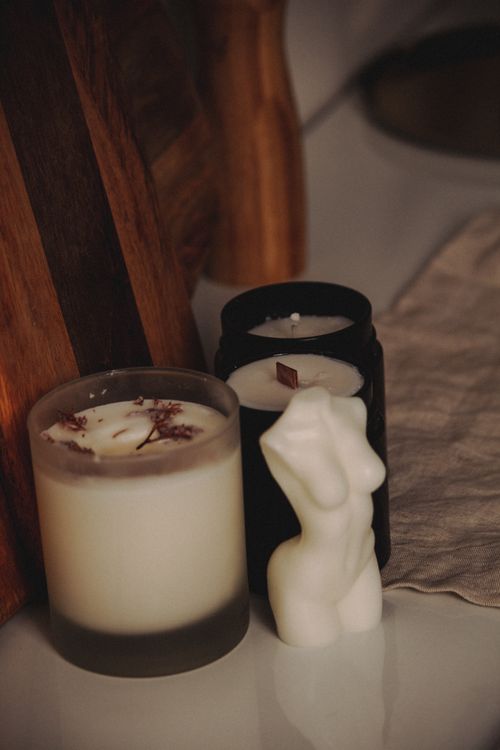 Free Beautiful arrangement of scented candles with a sculptural design on a white surface for a cozy ambiance. Stock Photo