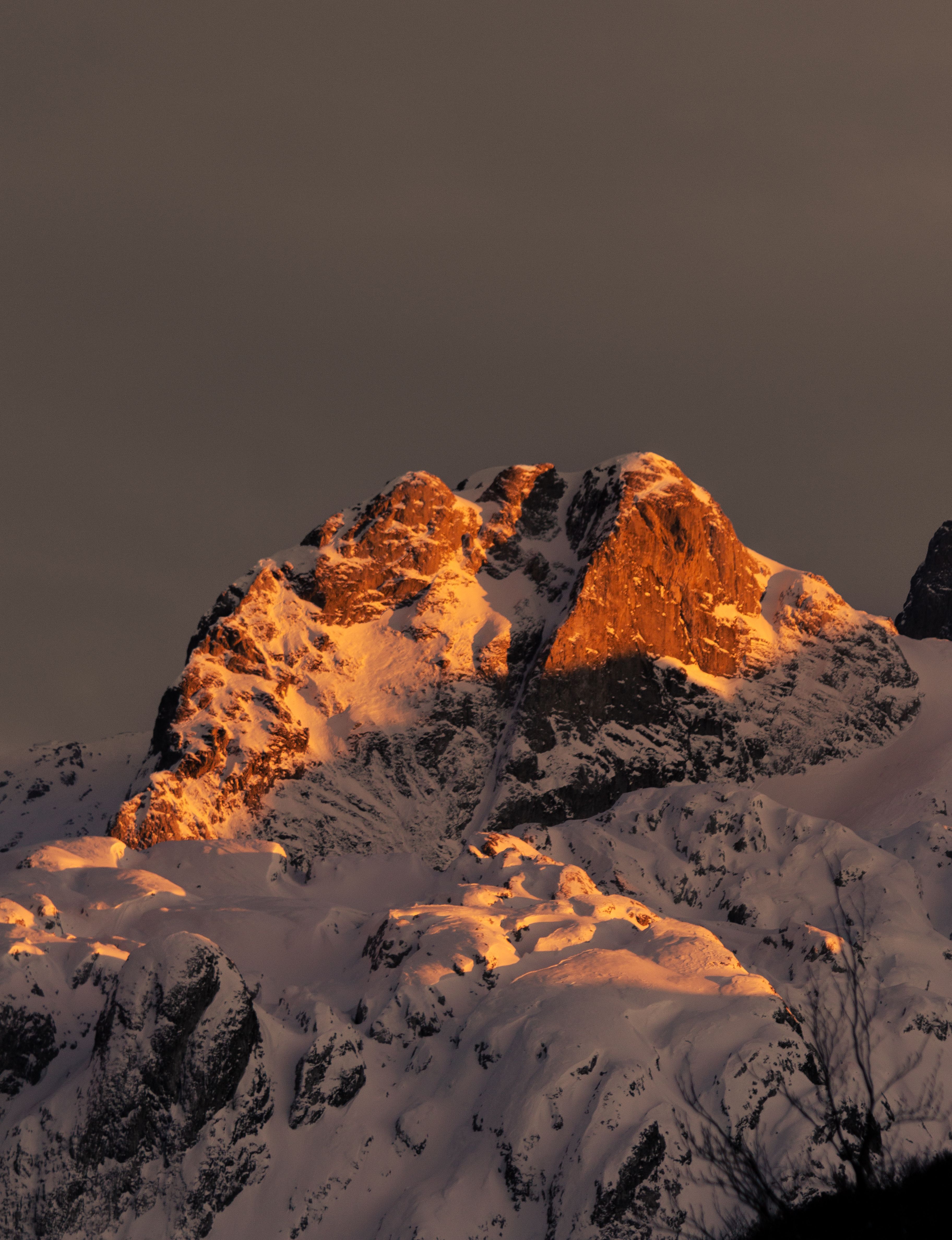 A Snow Covered Mountain during the Golden Hour · Free Stock Photo