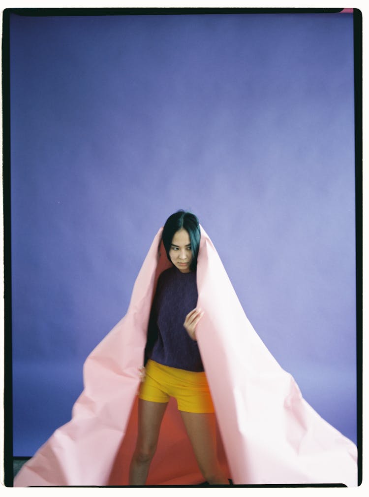 Woman Wearing Sheet Of Paper Like Cape