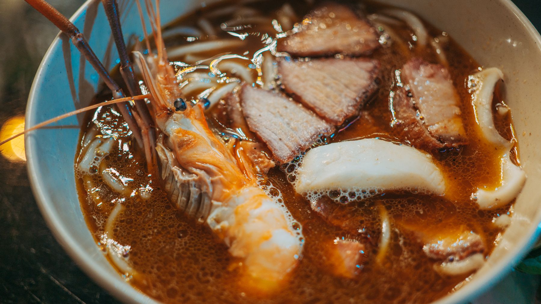 Mouthwatering seafood ramen with shrimp, pork, and noodles in a rich broth.