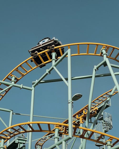 Free Roller Coaster Ride Under the Clear Blue Sky  Stock Photo
