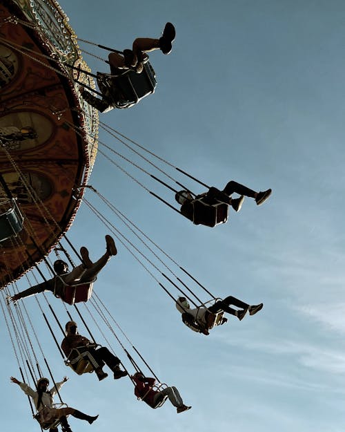 Free People Enjoying the Flying Chair Ride  Stock Photo