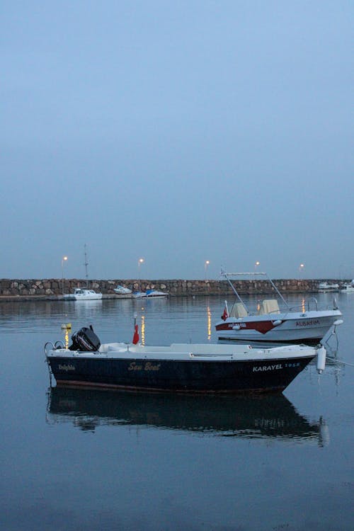 Boats Floating on the Calm Body of Water 