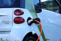 Close-up of an electric car being charged, highlighting eco-friendly transportation.