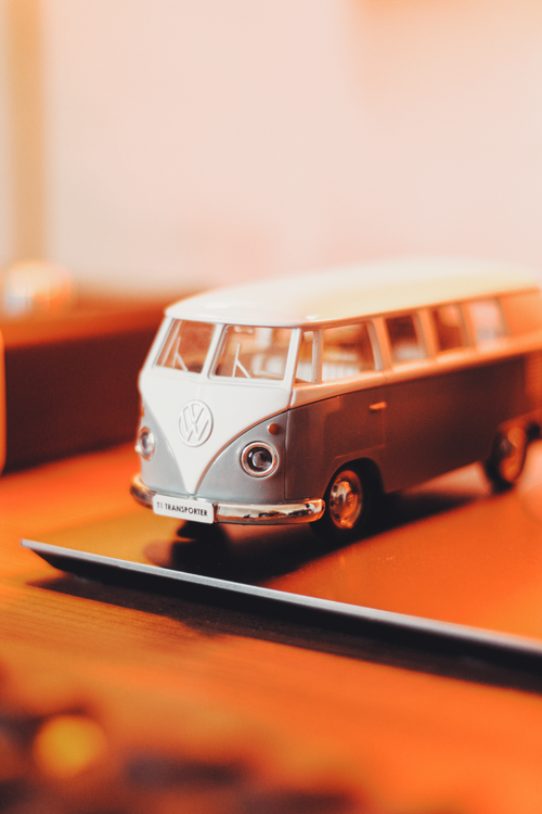 Free Selective focus on a classic Volkswagen Kombi toy model in warm indoor lighting. Stock Photo
