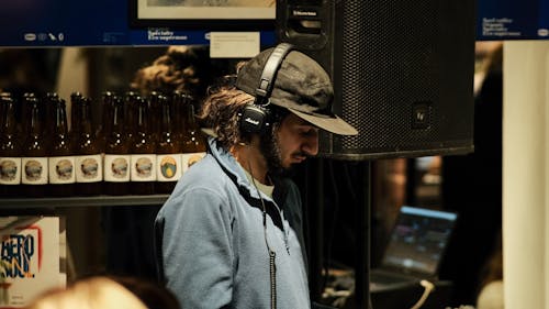 Man in Headphones Working in Club
