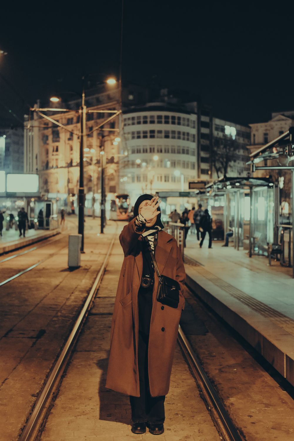 Woman in Brown Coat Standing on a Railway Track · Free Stock Photo
