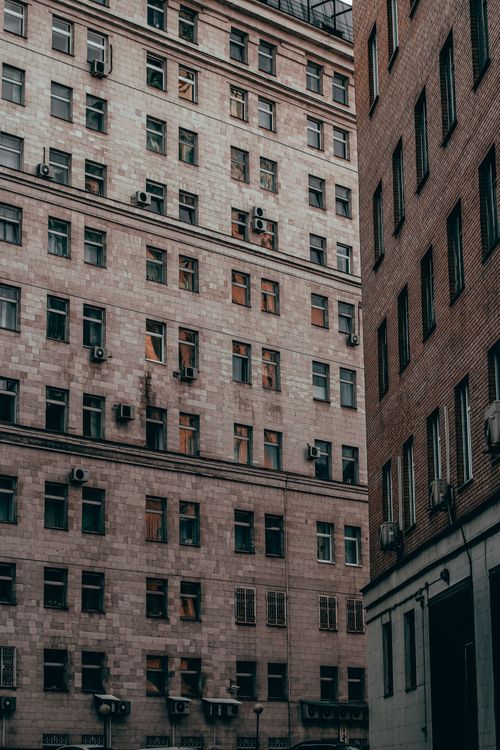 Free Vertical view of Moscow's urban architecture featuring buildings with air conditioners and windows. Stock Photo