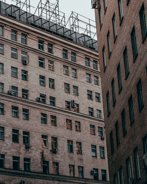 Free Aerial view of urban buildings in Moscow with air conditioners and glass windows. Stock Photo