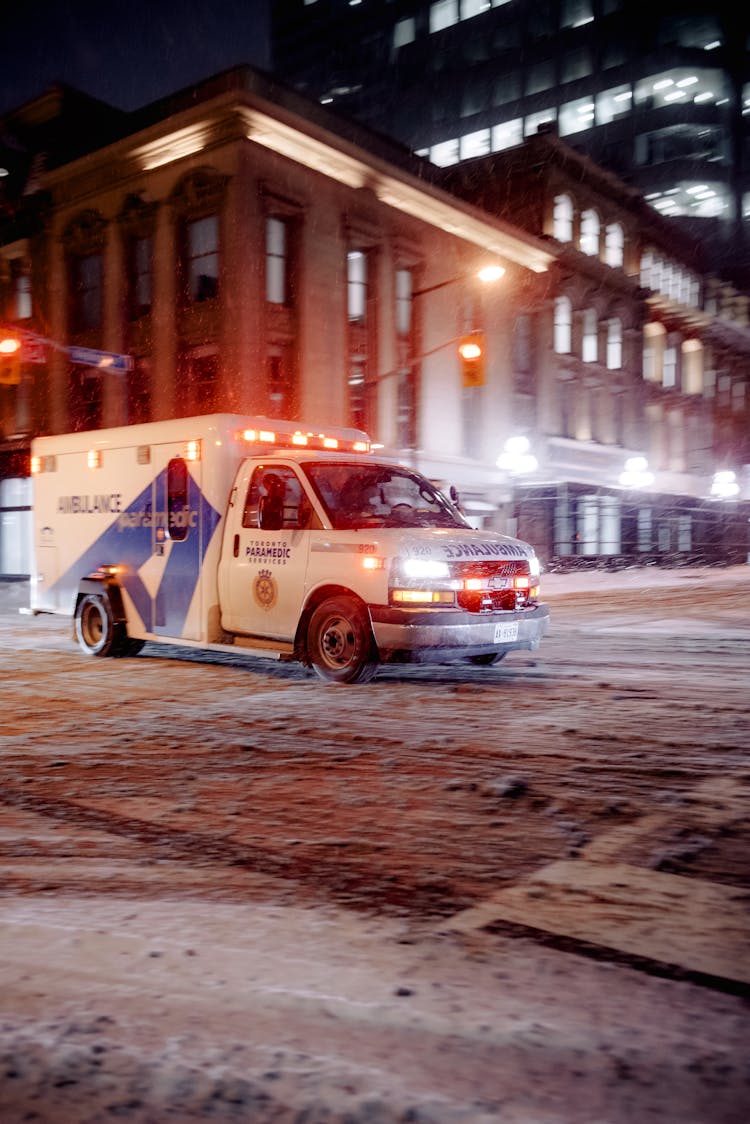 Ambulance Driving Through City At Night