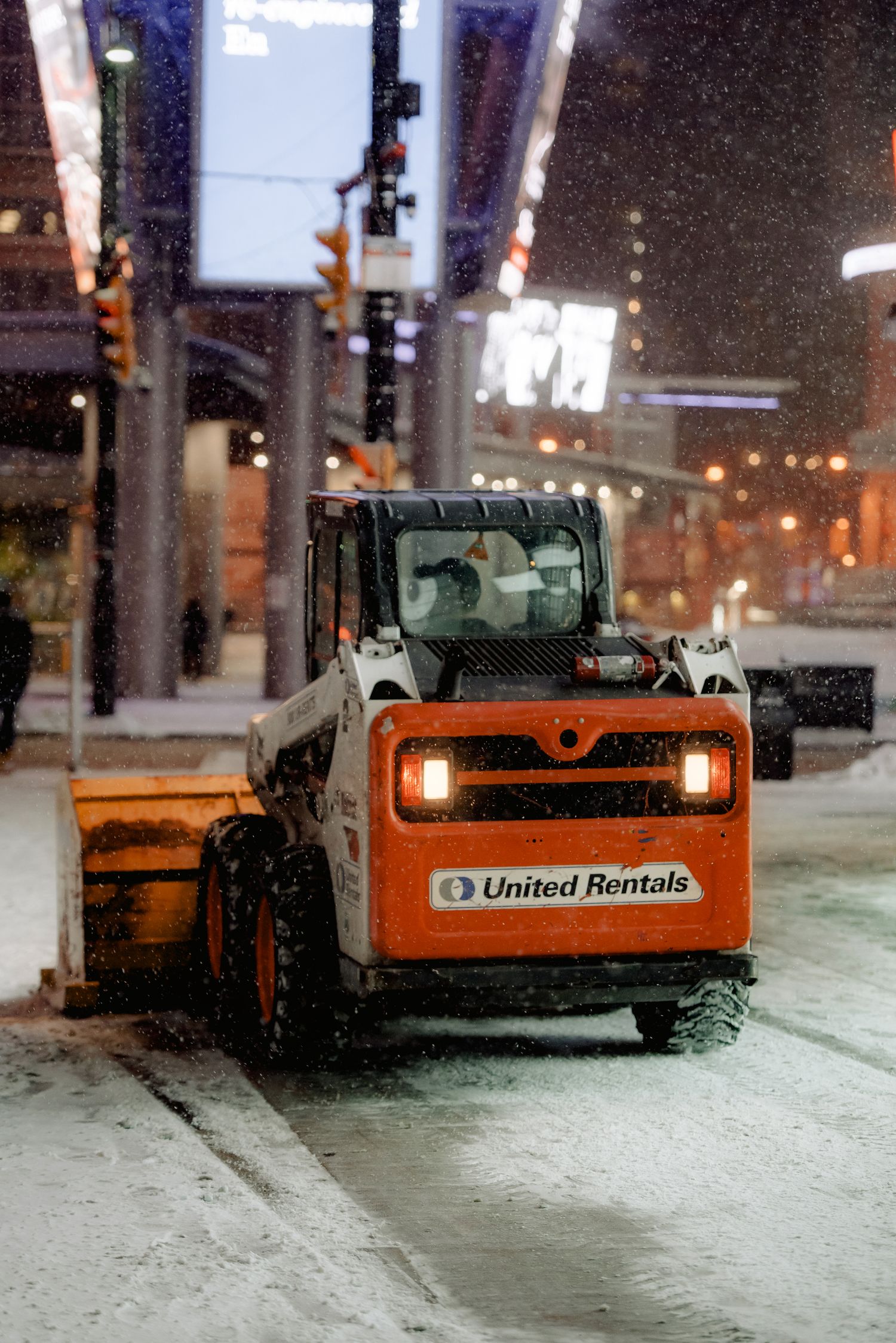 Night snow plowing commercial lot