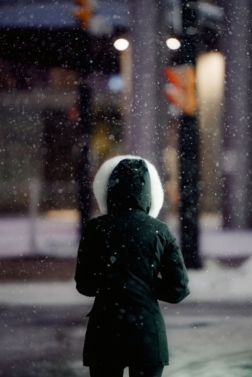 A Person Standing in a City in Winter