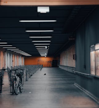 An empty indoor bicycle parking hallway in Munich, Germany with modern lighting.